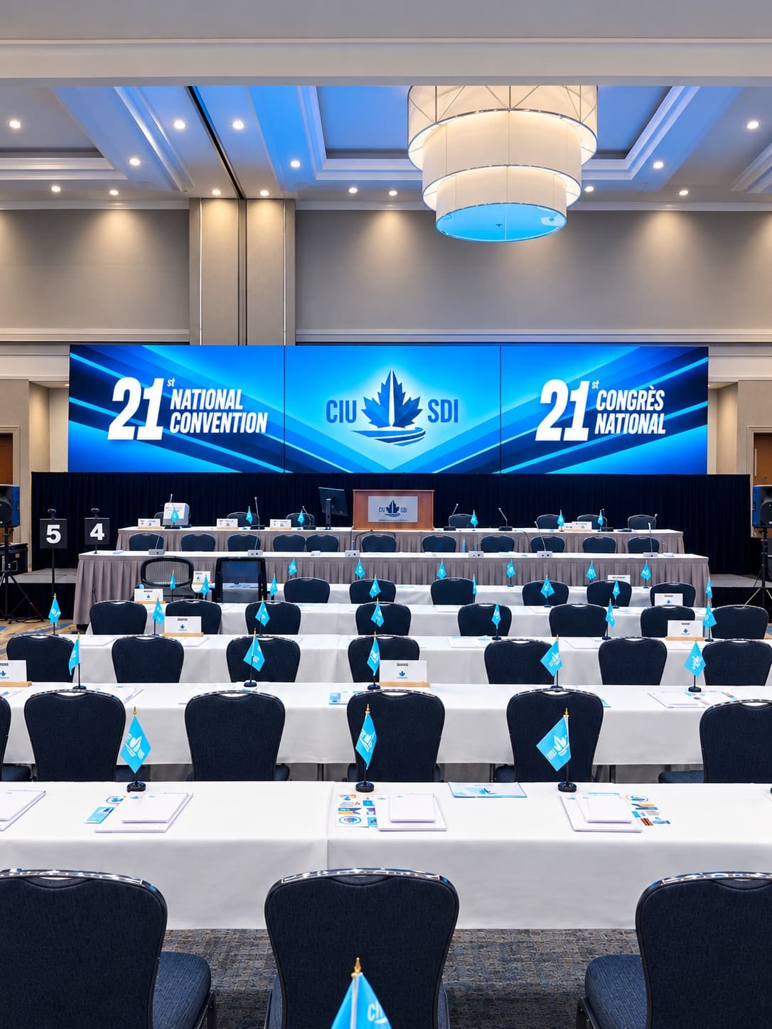 Hotel ballroom set for the CIU-SDI 21st National Convention, with a wide LED wall above the head table